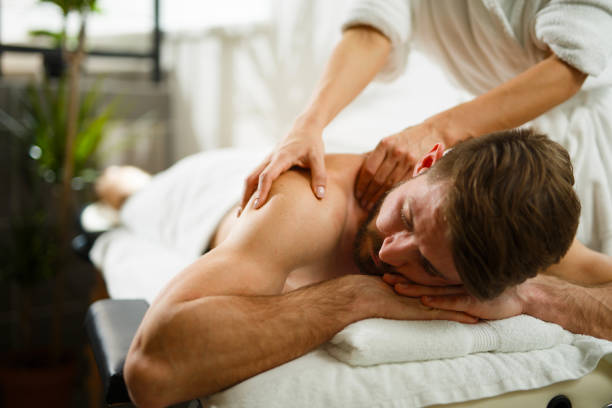 Man having back massage in the health spa. Copy space.